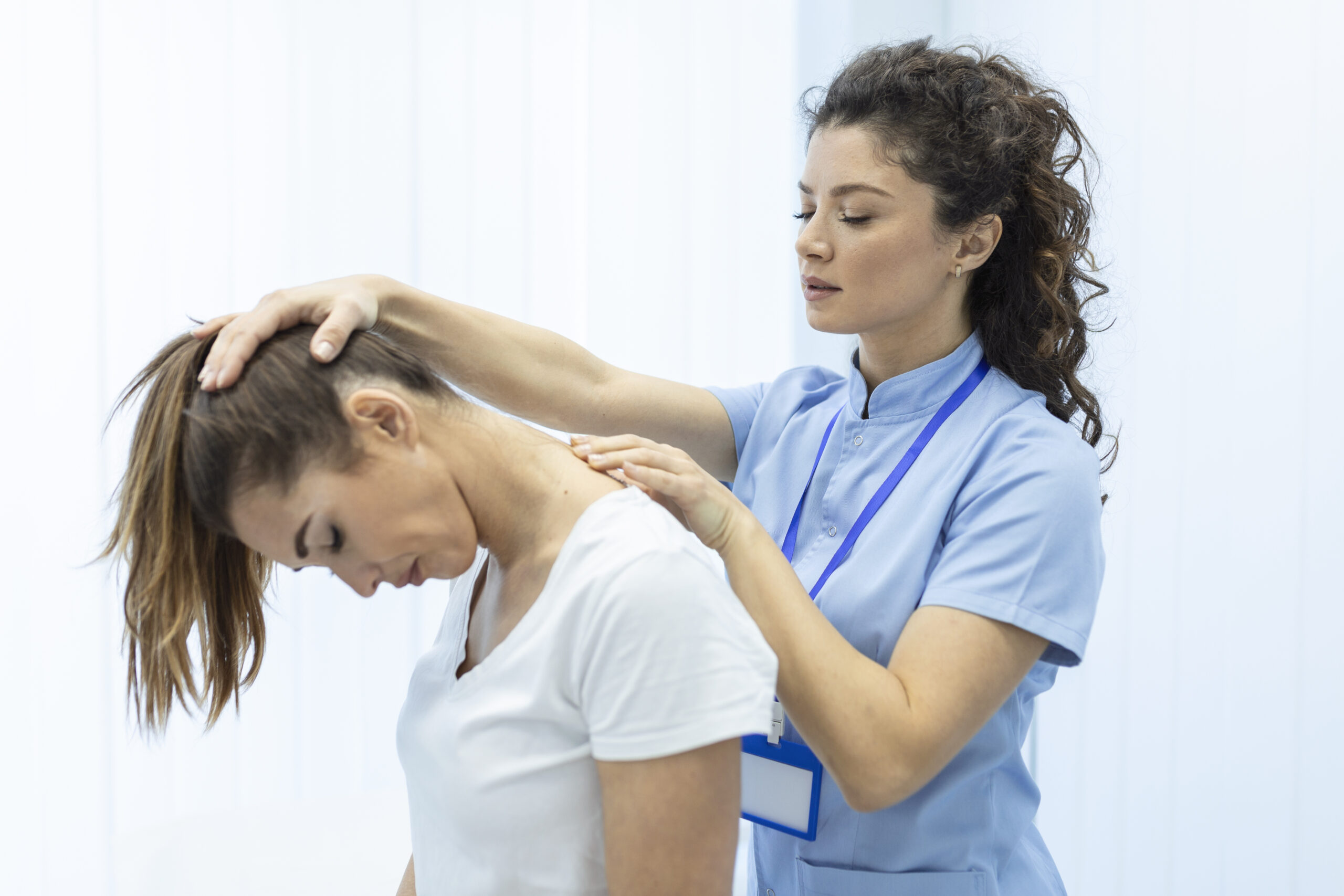 physiotherapist doing healing treatment on womans neck,chiropractic adjustment, pain relief concept.office syndrome